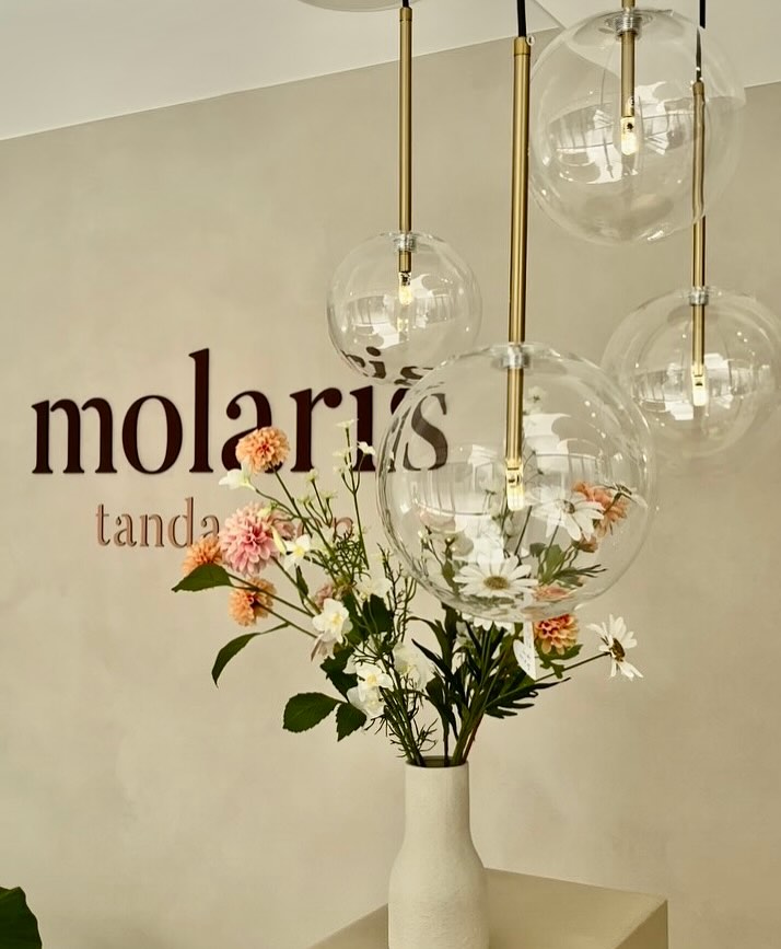 Close-up of glass globe pendants with brass fittings
