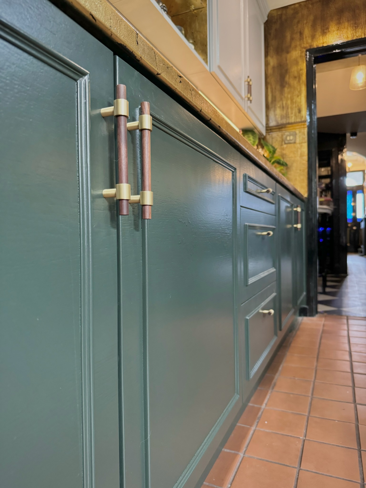 Close-up of CIRCA handles on blue cabinetry