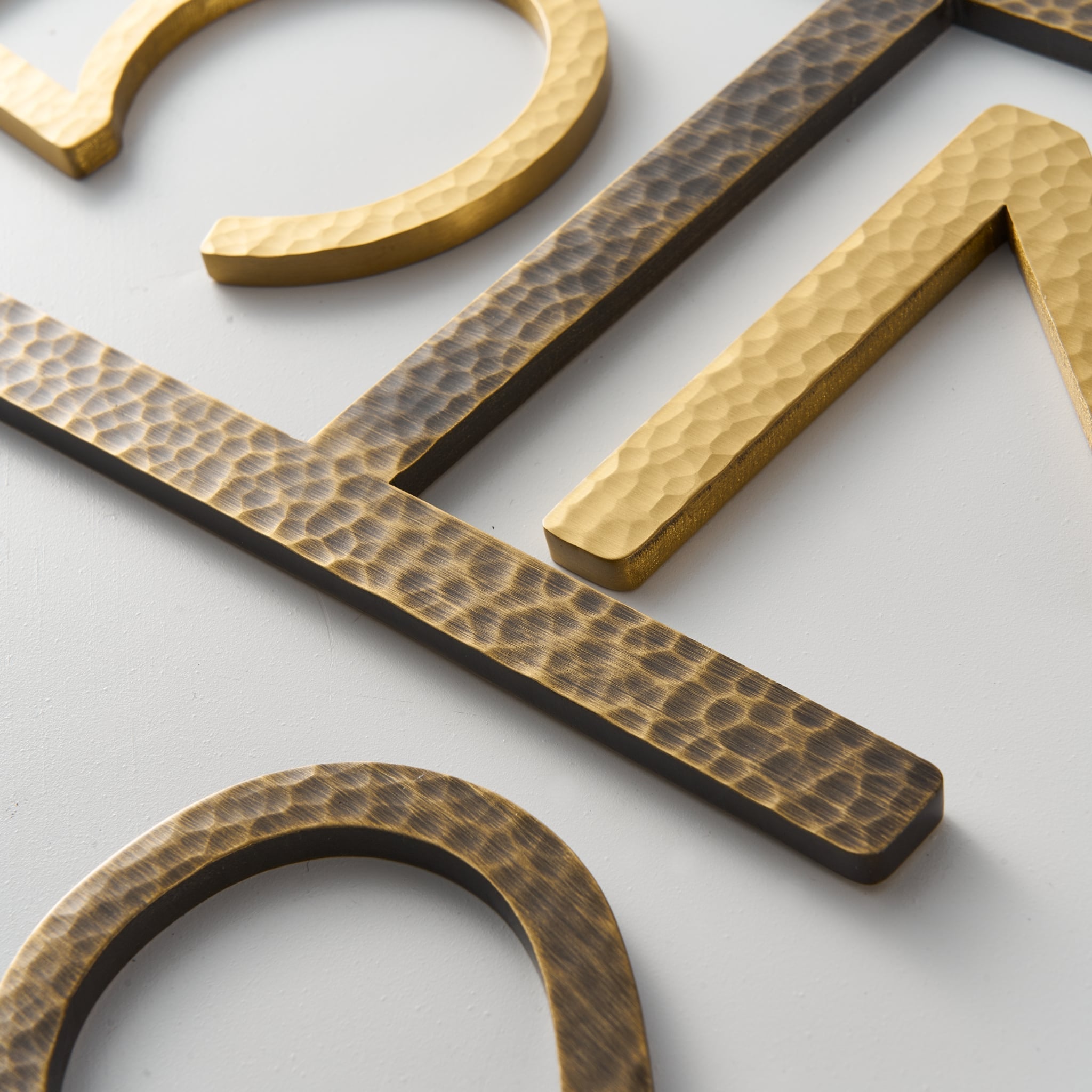 EZRA Characters in Hammered Antique Brass